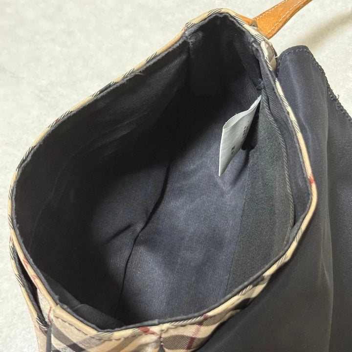 Burberry beige Nova Check crossbody handbag with black nylon flap and leather strap.
