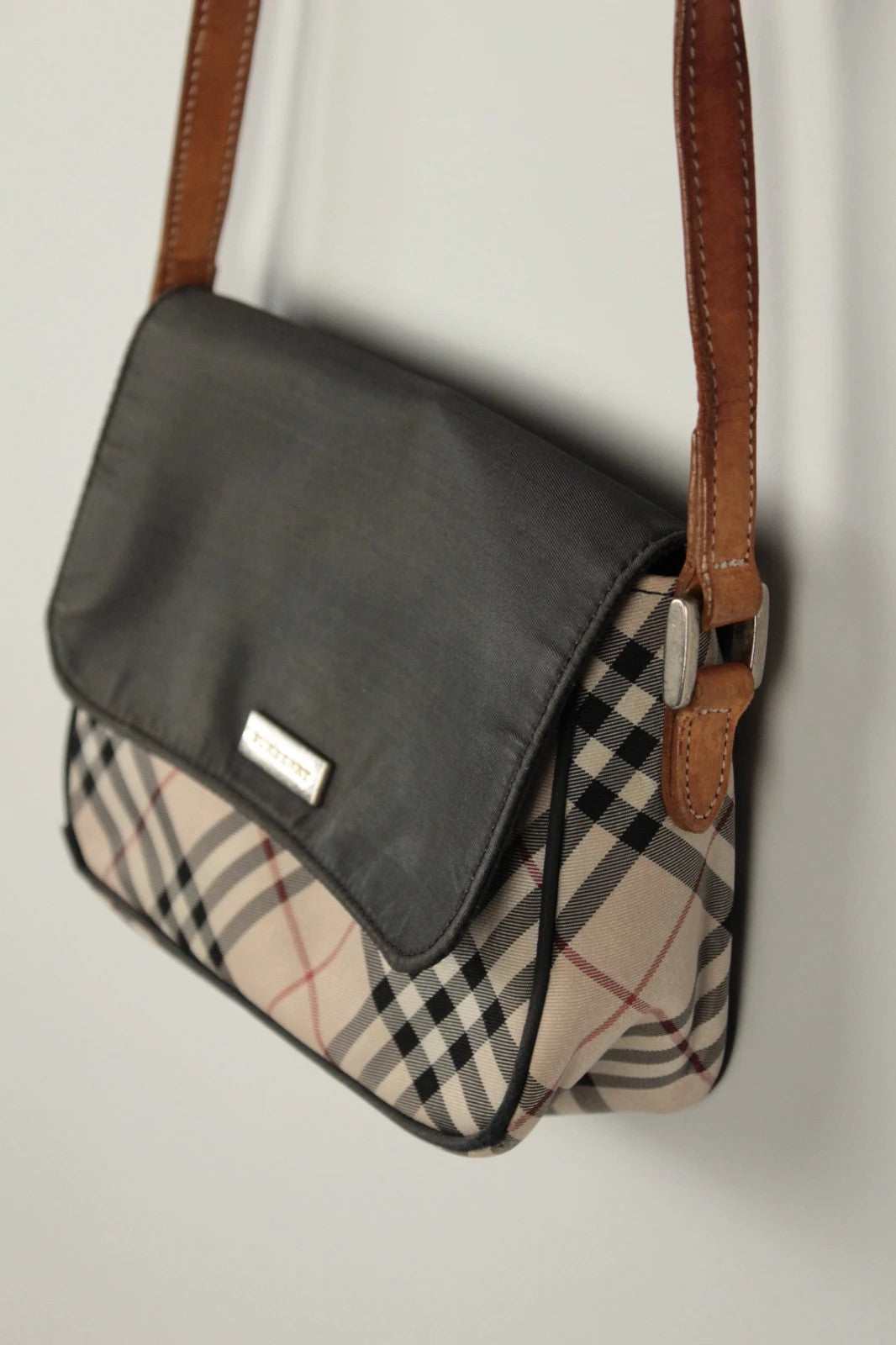 Burberry beige Nova Check crossbody handbag with black nylon flap and leather strap.