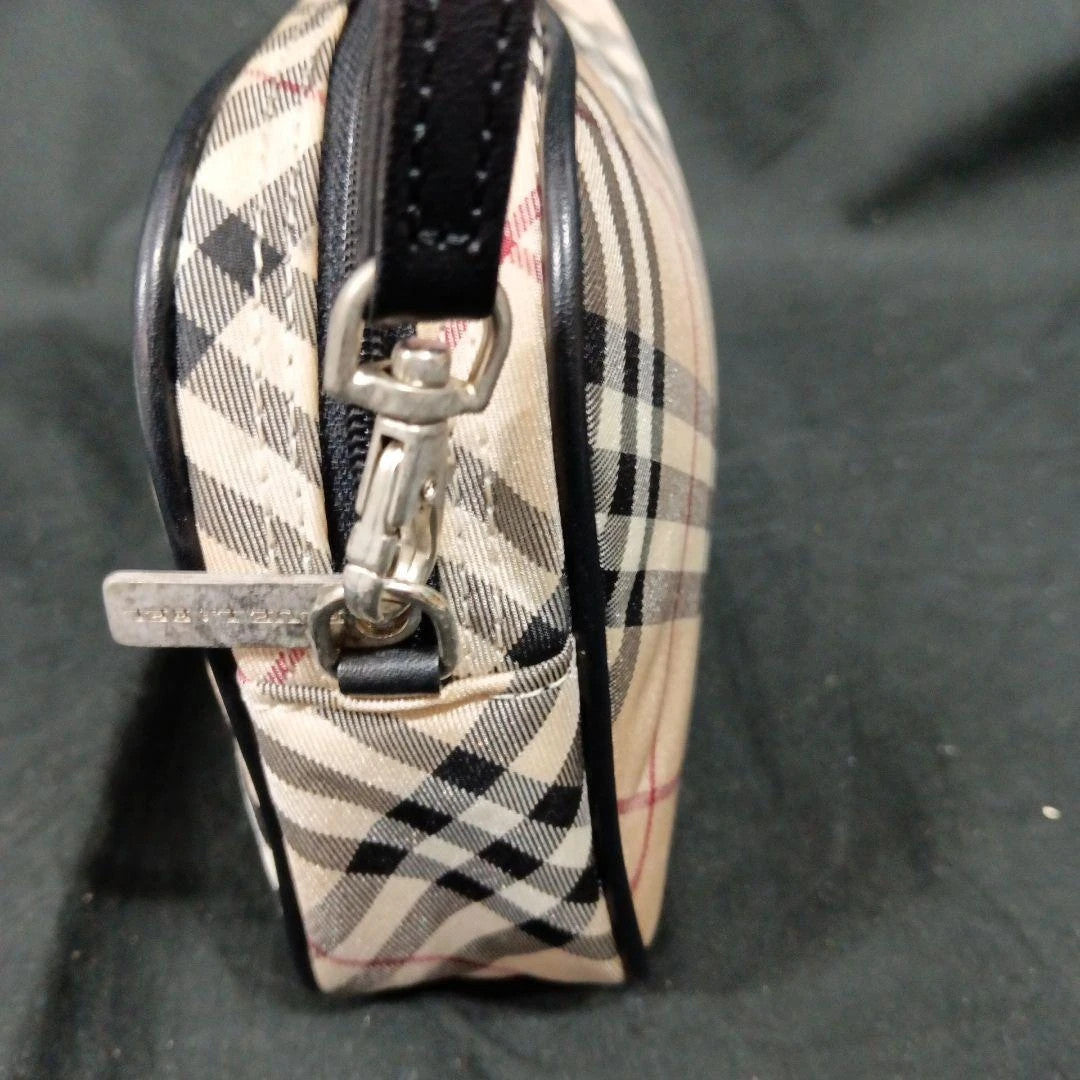 Burberry beige Nova Check mini handbag with black leather trim and silver-tone hardware.