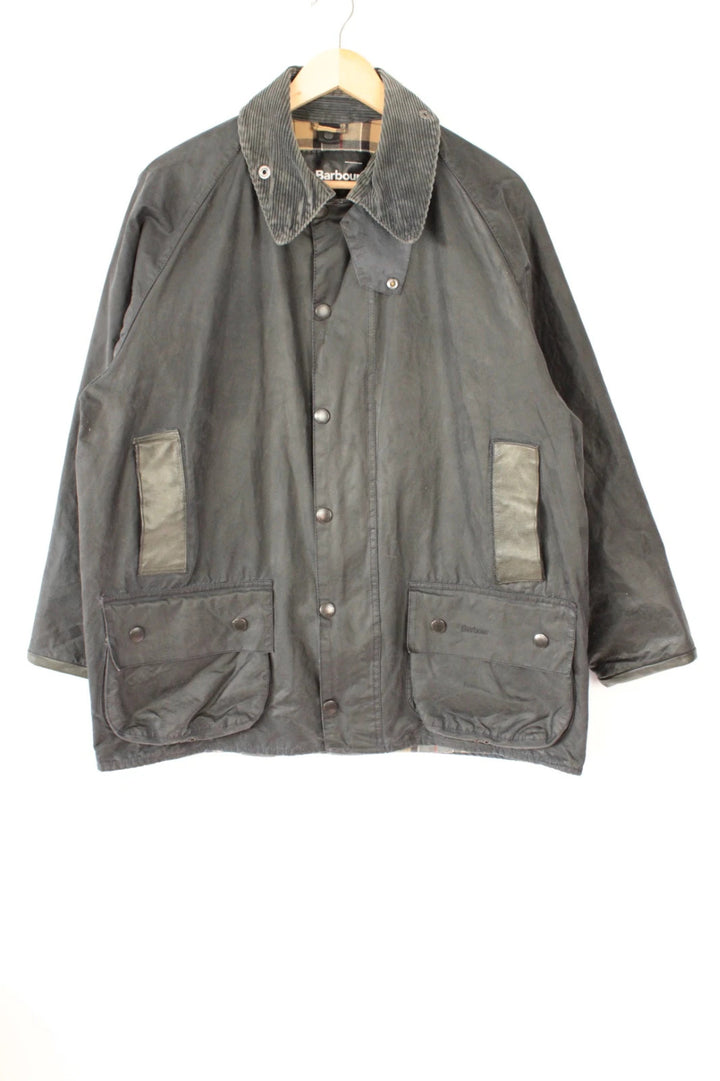 Barbour grey Beaufort wax jacket with navy pocket panels and thick corduroy collar.