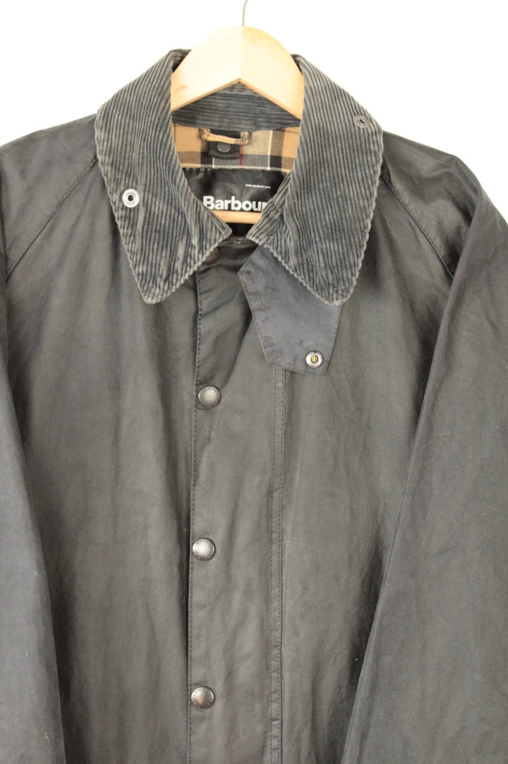 Barbour grey Beaufort wax jacket with navy pocket panels and thick corduroy collar.