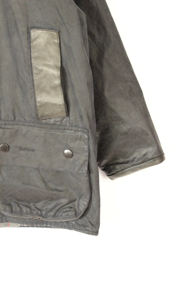 Barbour grey Beaufort wax jacket with navy pocket panels and thick corduroy collar.