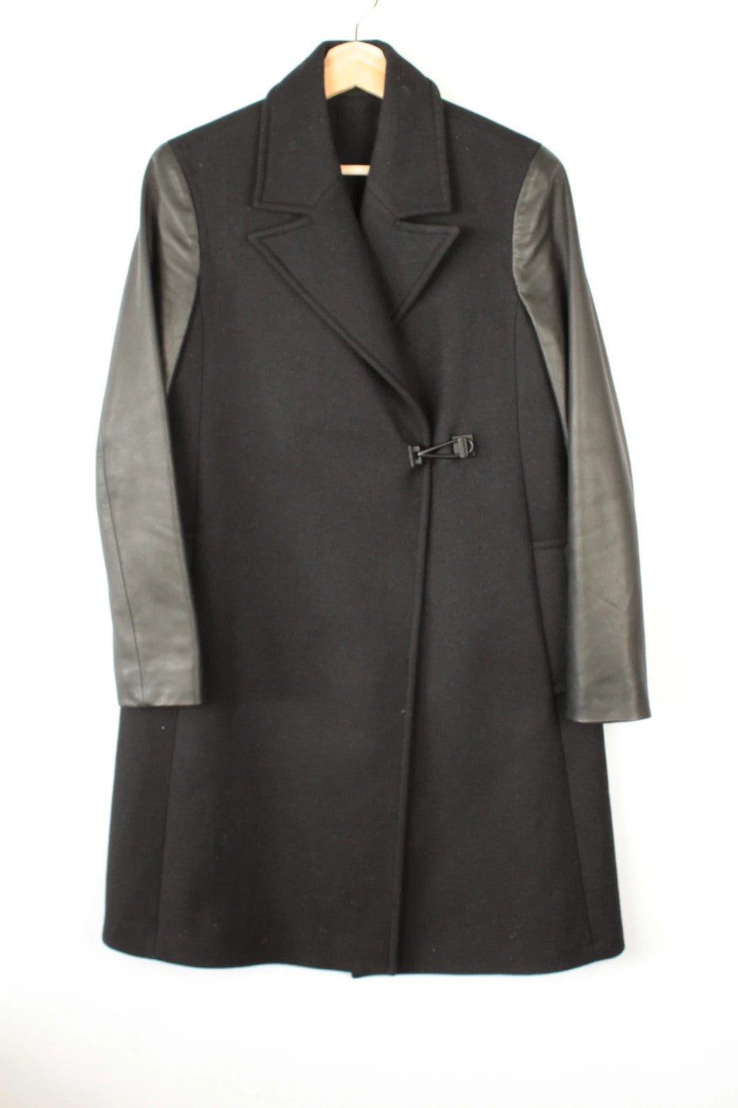 AllSaints black coat with lamb leather sleeves and industrial metal hook buckle fastener.