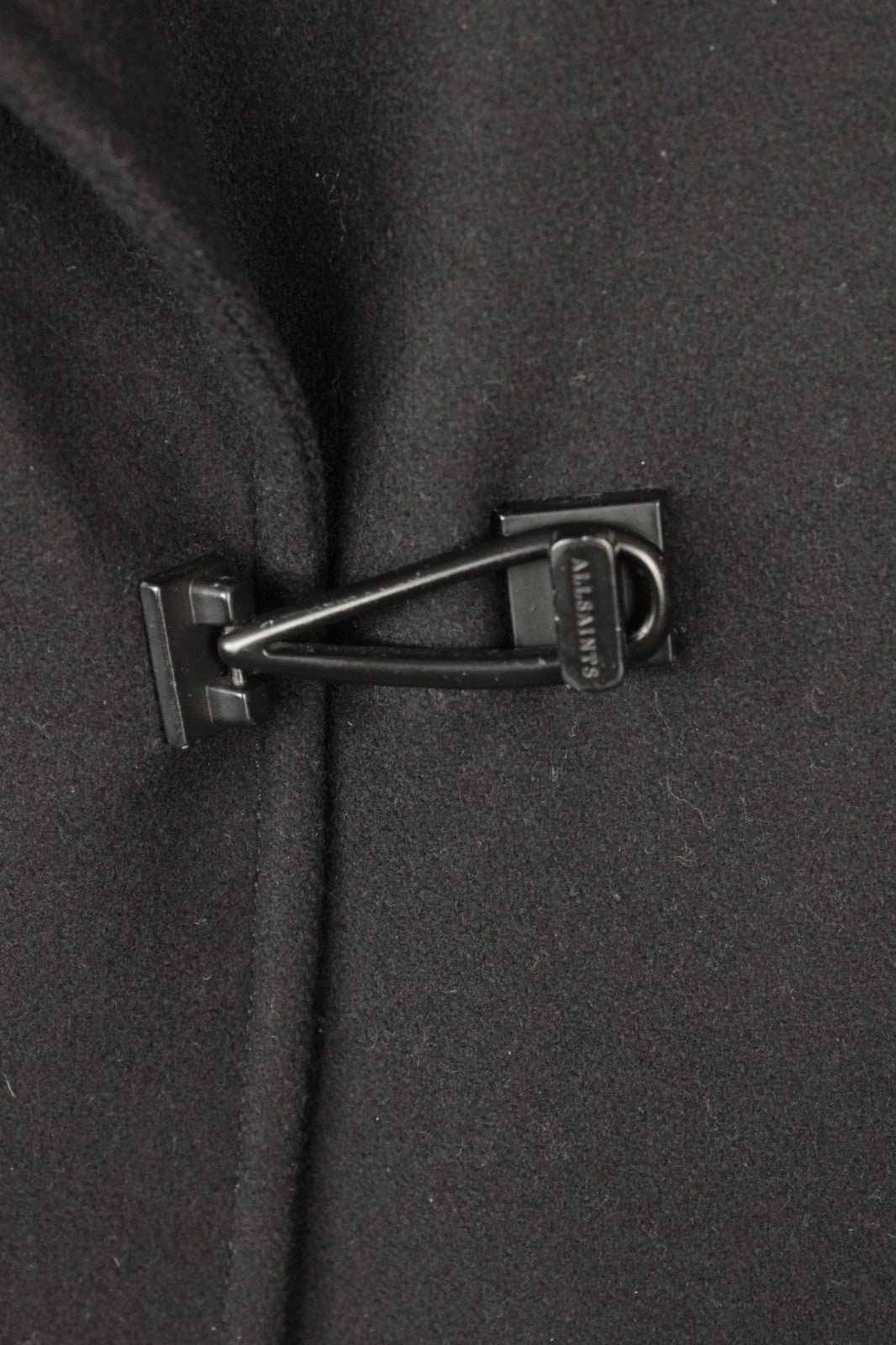 AllSaints black coat with lamb leather sleeves and industrial metal hook buckle fastener.