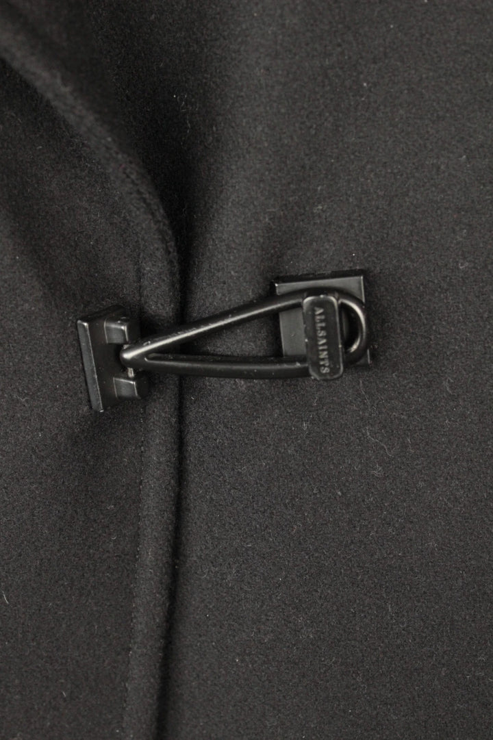 AllSaints black coat with lamb leather sleeves and industrial metal hook buckle fastener.