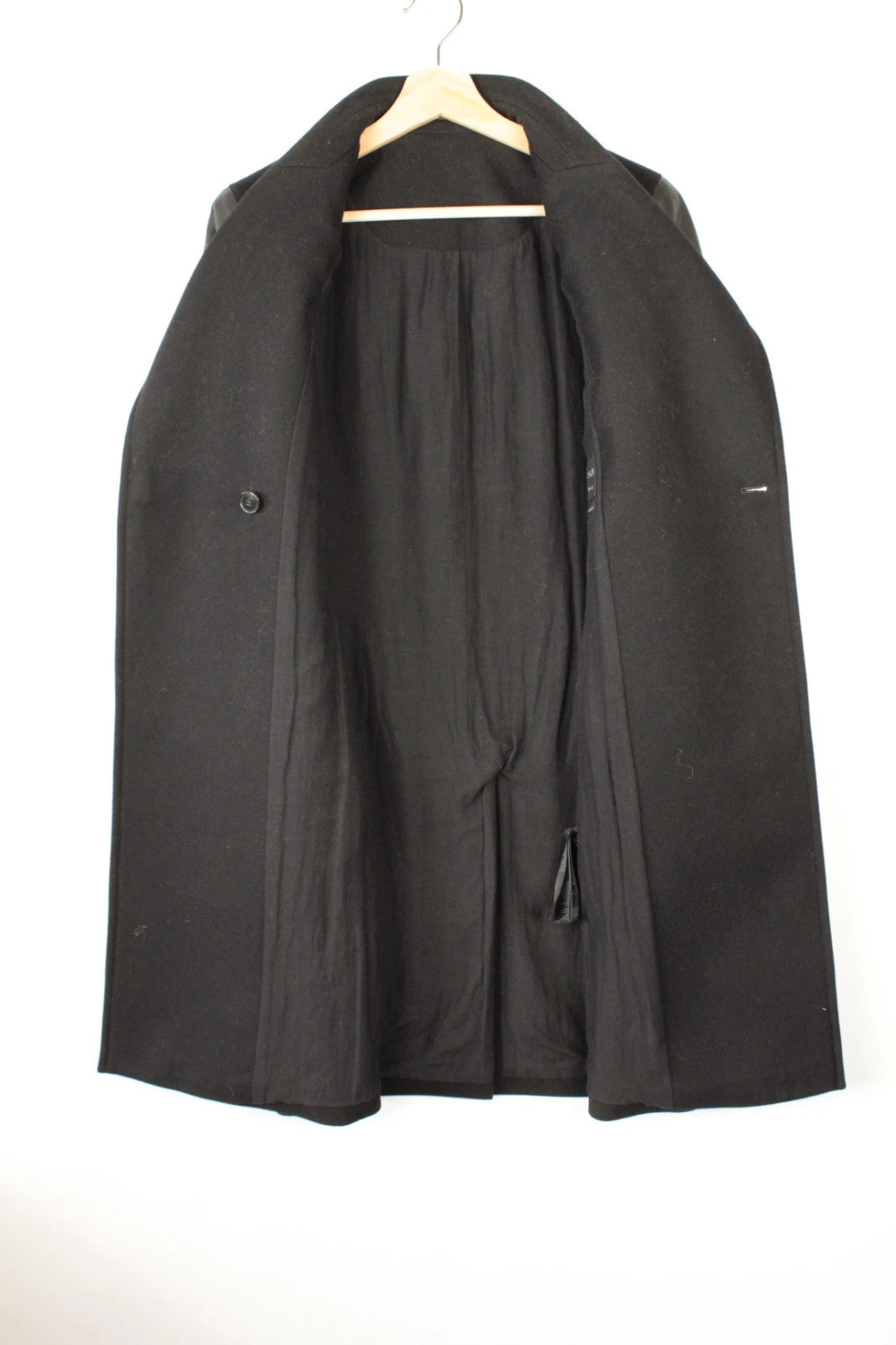 AllSaints black coat with lamb leather sleeves and industrial metal hook buckle fastener.