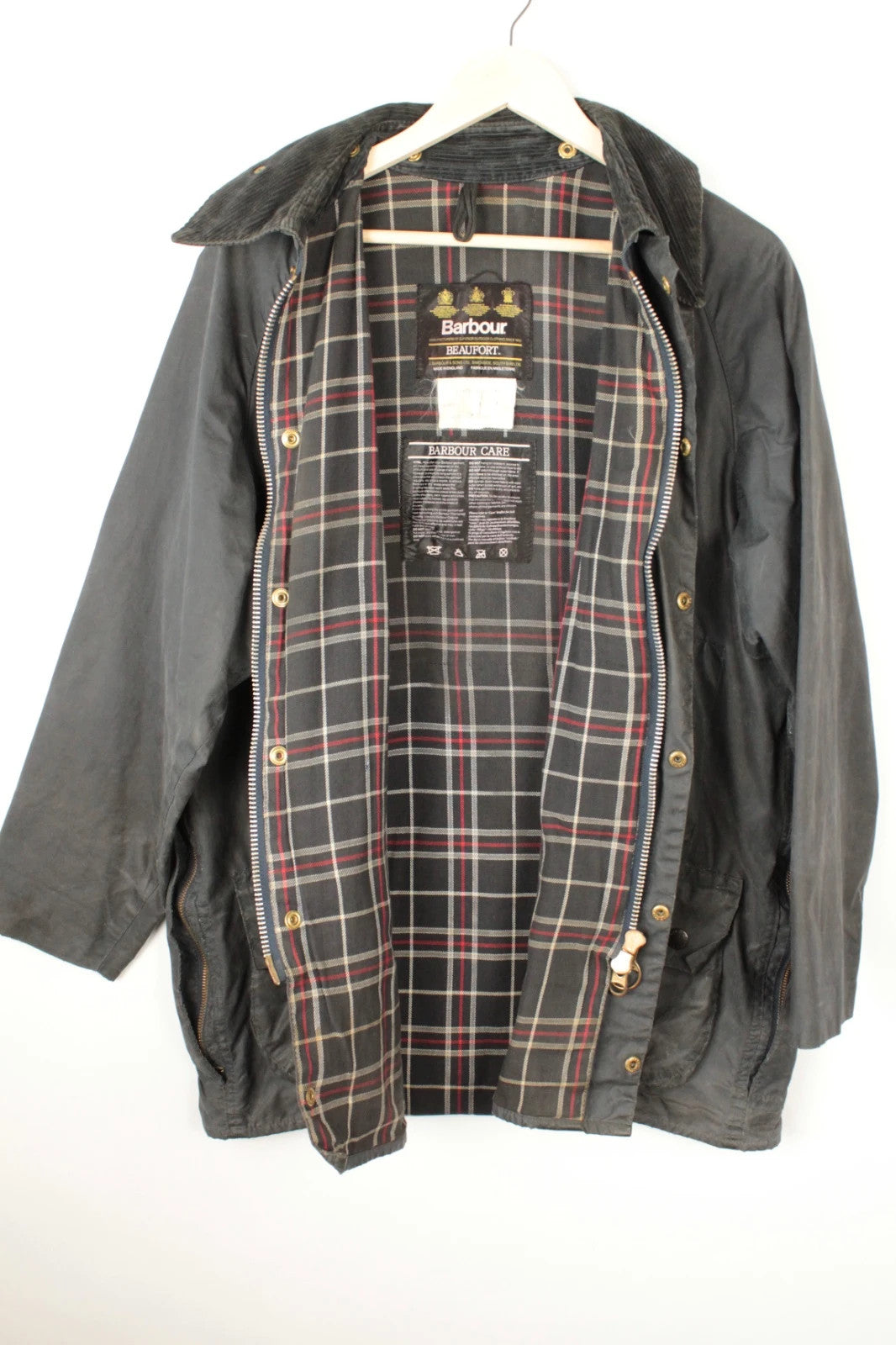 Barbour black and navy waxed cotton jacket with corduroy collar and Levi's patchwork details.