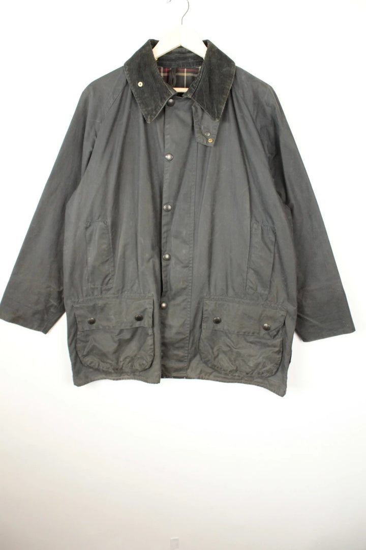 Barbour black and navy waxed cotton jacket with corduroy collar and Levi's patchwork details.
