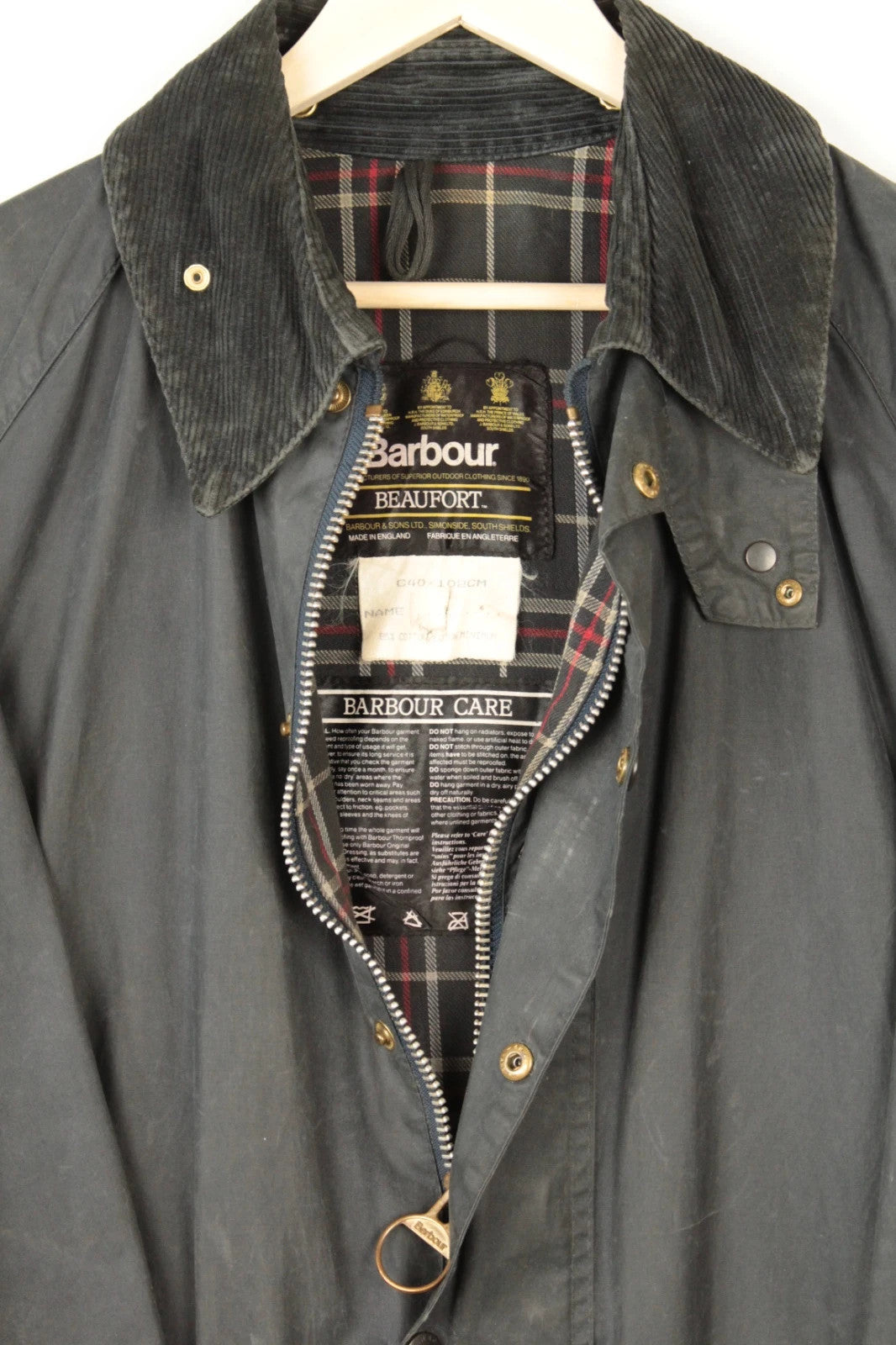 Barbour black and navy waxed cotton jacket with corduroy collar and Levi's patchwork details.