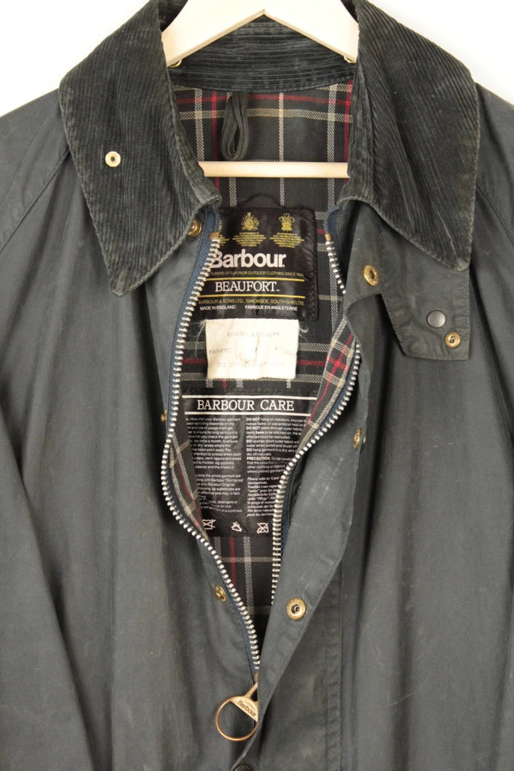 Barbour black and navy waxed cotton jacket with corduroy collar and Levi's patchwork details.