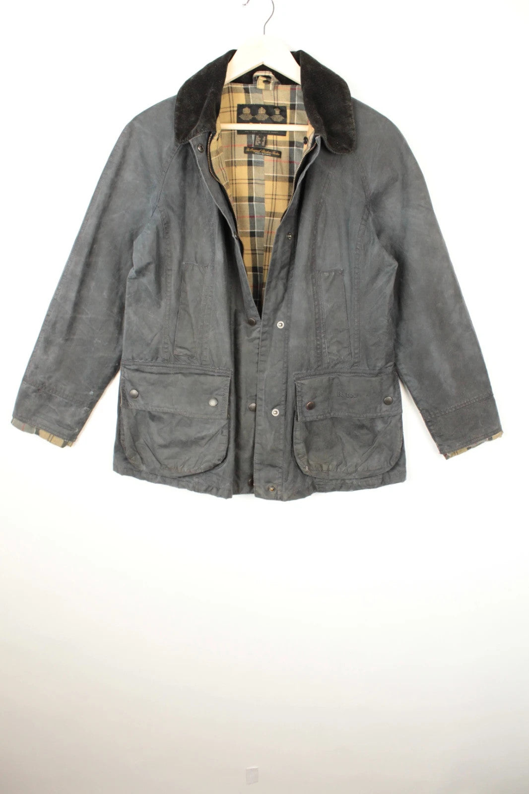 Barbour grey navy waxed cotton jacket with tartan lining and corduroy collar.