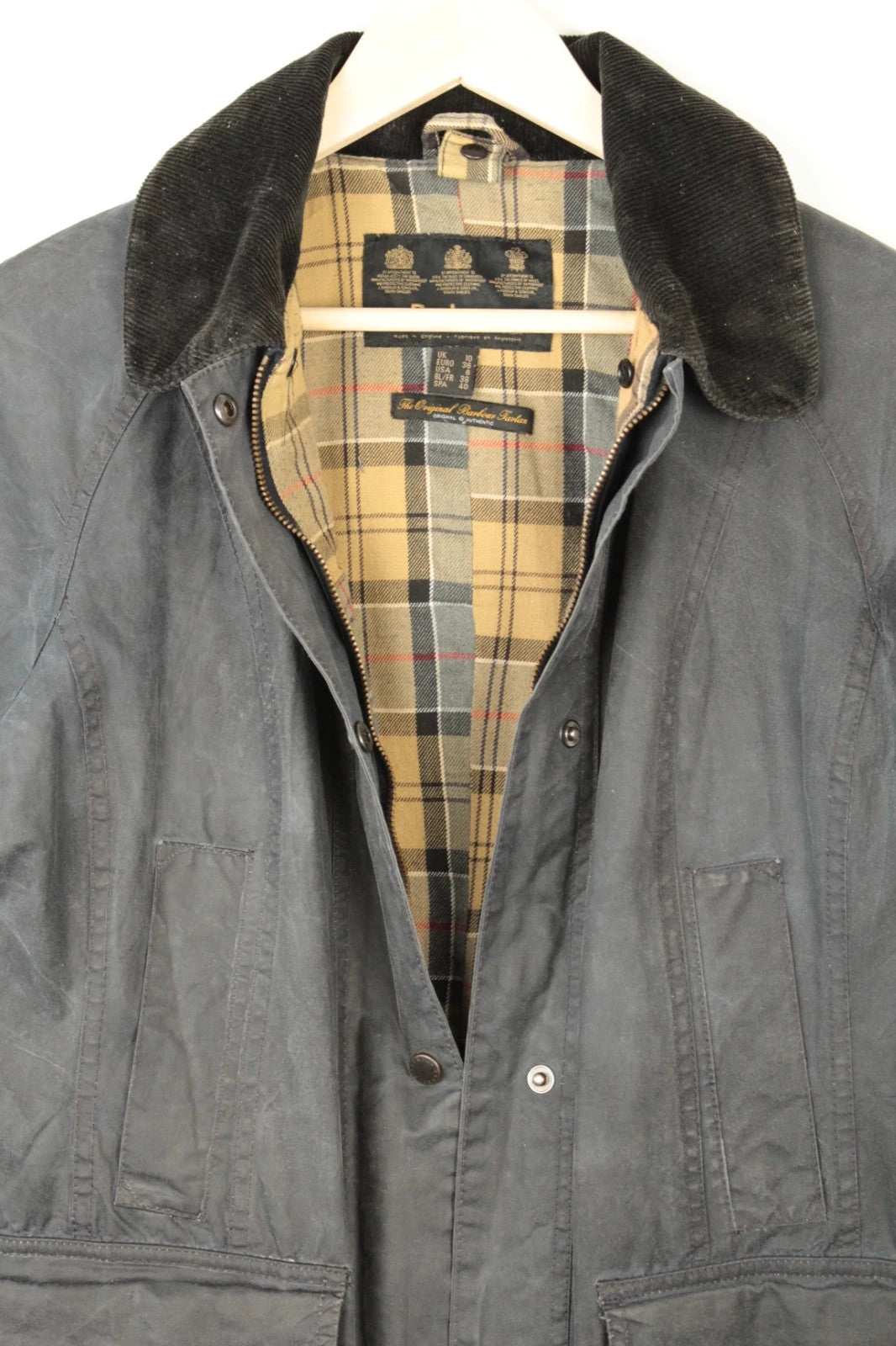 Barbour grey navy waxed cotton jacket with tartan lining and corduroy collar.
