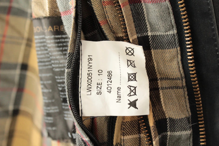 Barbour grey navy waxed cotton jacket with tartan lining and corduroy collar.