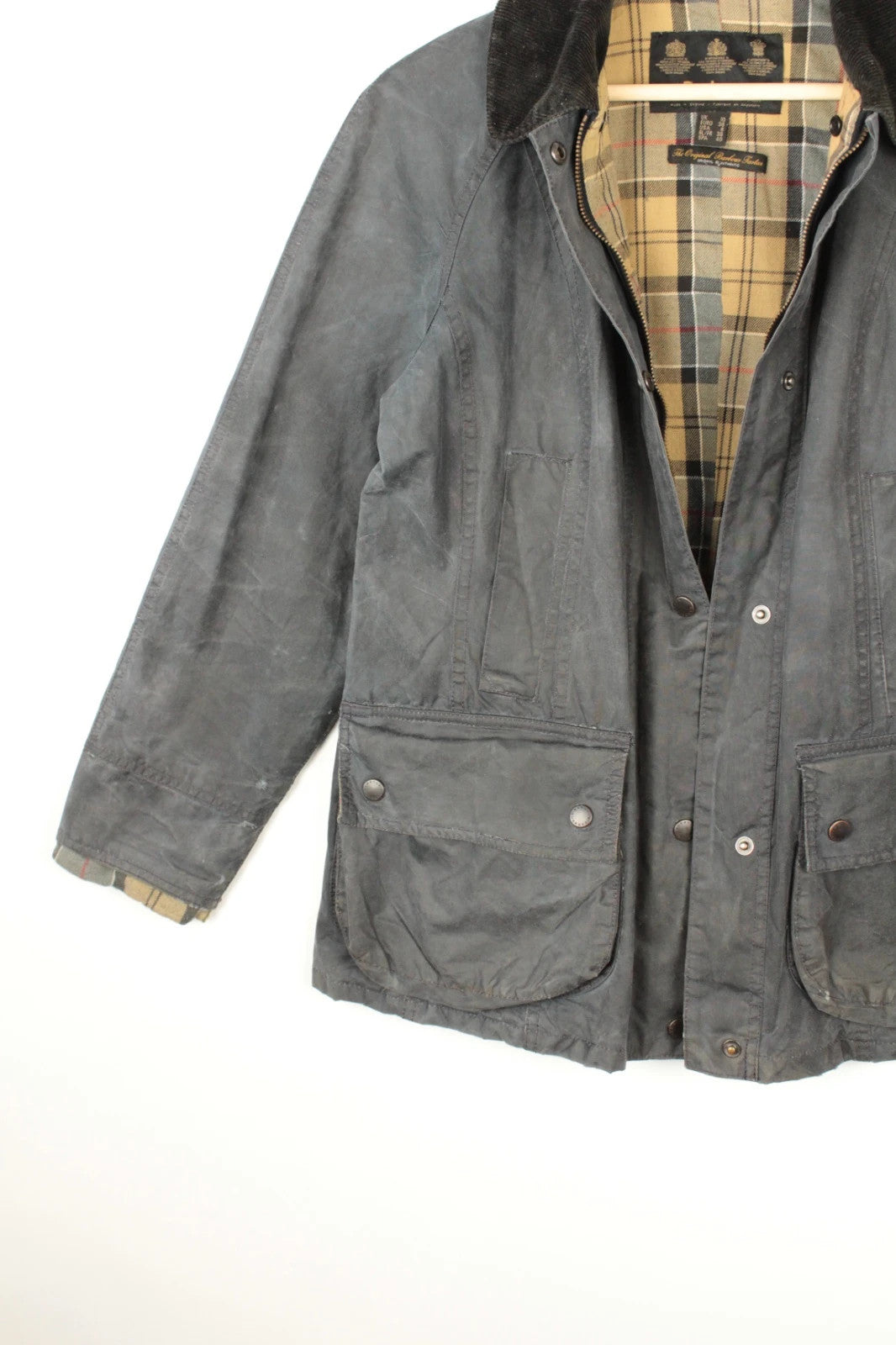 Barbour grey navy waxed cotton jacket with tartan lining and corduroy collar.