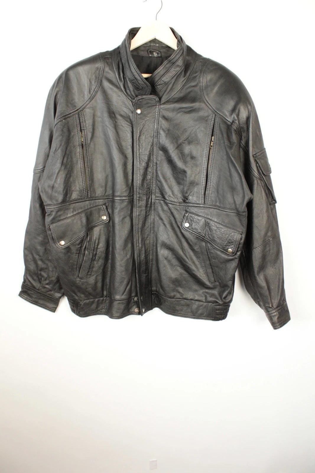 Vintage Dressing black leather bomber jacket with geometric panel stitching and multi-pocket design.