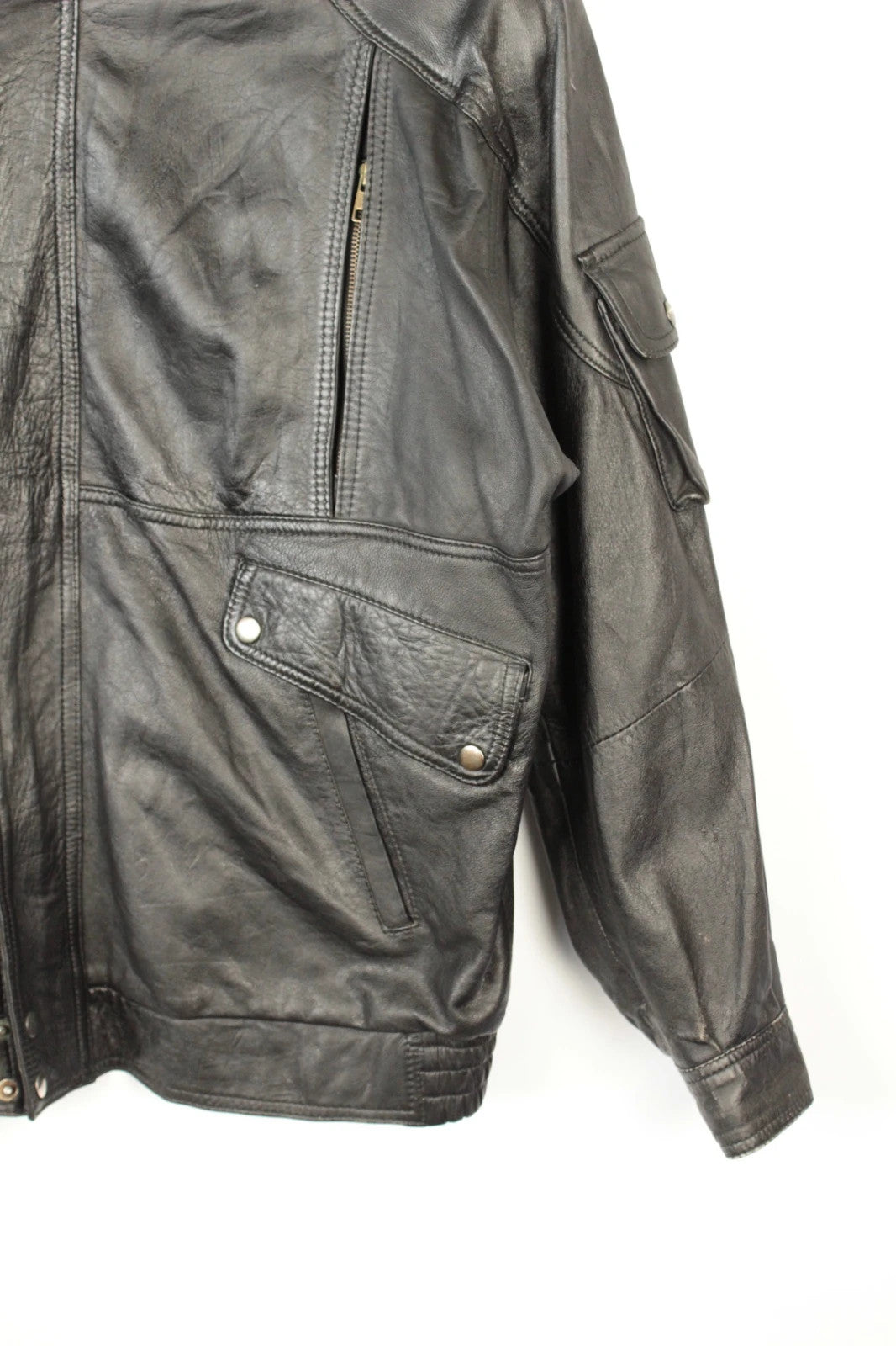 Vintage Dressing black leather bomber jacket with geometric panel stitching and multi-pocket design.