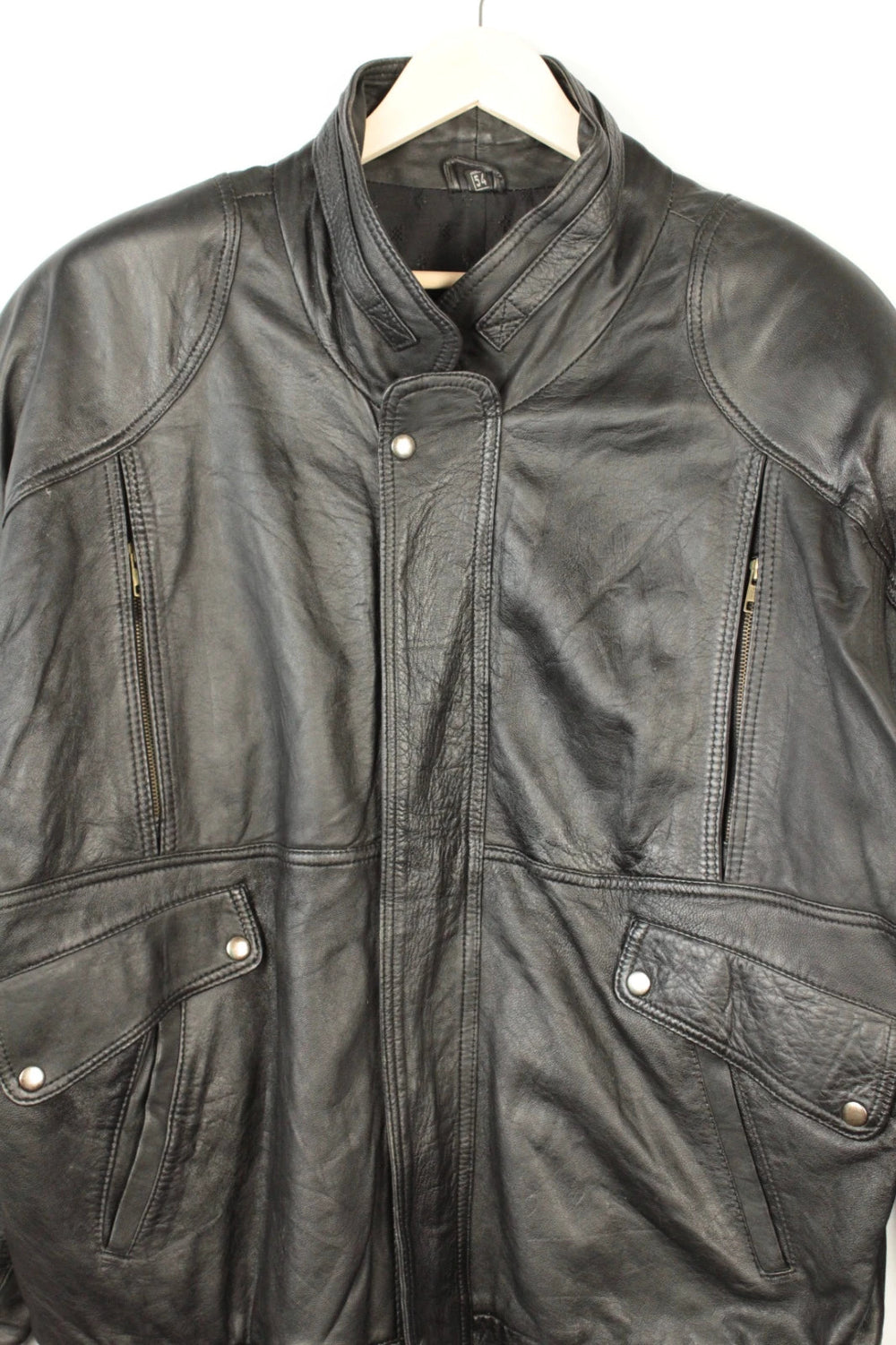 Vintage Dressing black leather bomber jacket with geometric panel stitching and multi-pocket design.