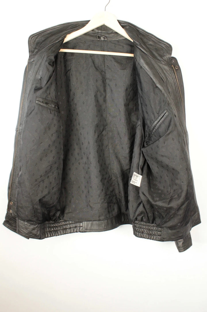 Vintage Dressing black leather bomber jacket with geometric panel stitching and multi-pocket design.