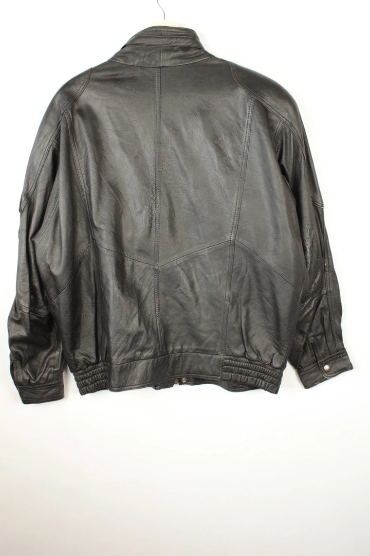 Vintage Dressing black leather bomber jacket with geometric panel stitching and multi-pocket design.