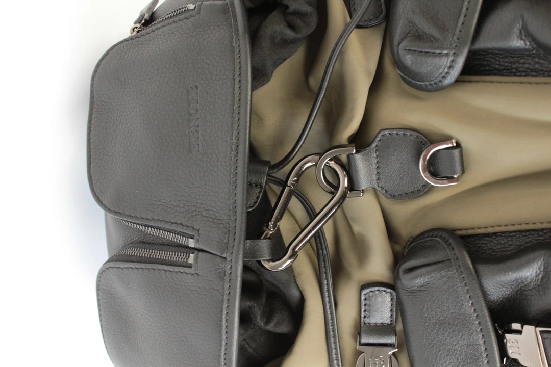 Hènope black and military green neoprene backpack with calf leather trim and gunmetal hardware.