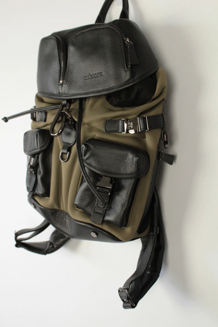 Hènope black and military green neoprene backpack with calf leather trim and gunmetal hardware.