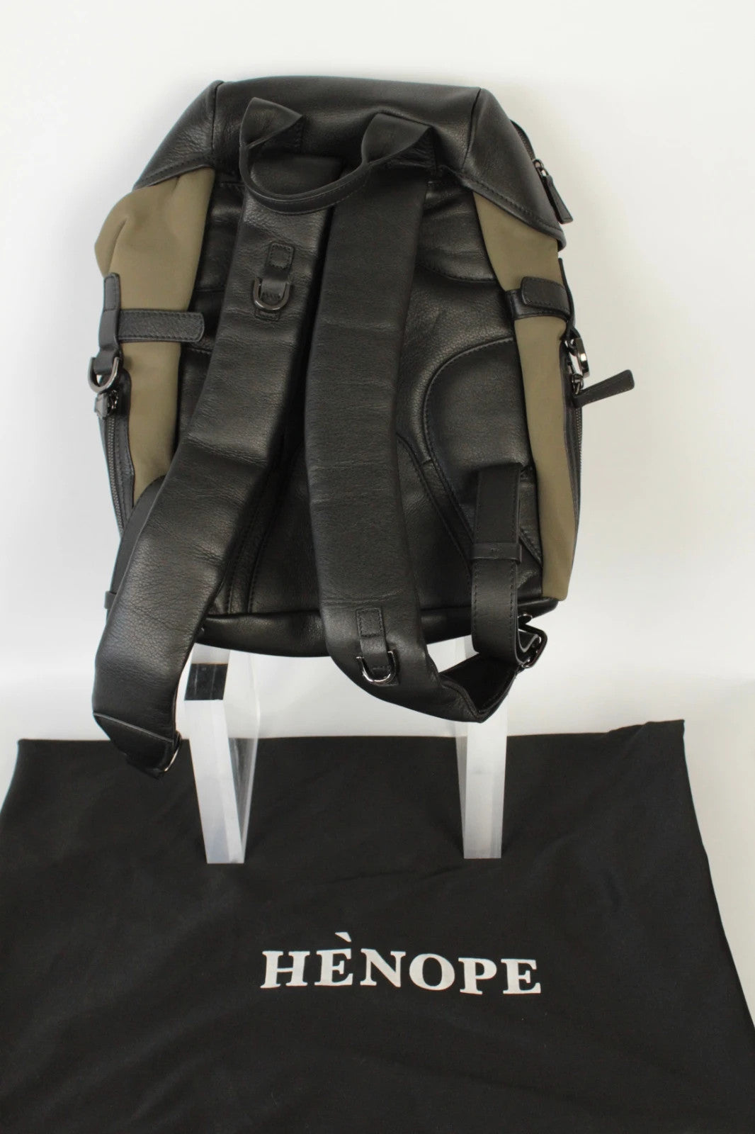 Hènope black and military green neoprene backpack with calf leather trim and gunmetal hardware.