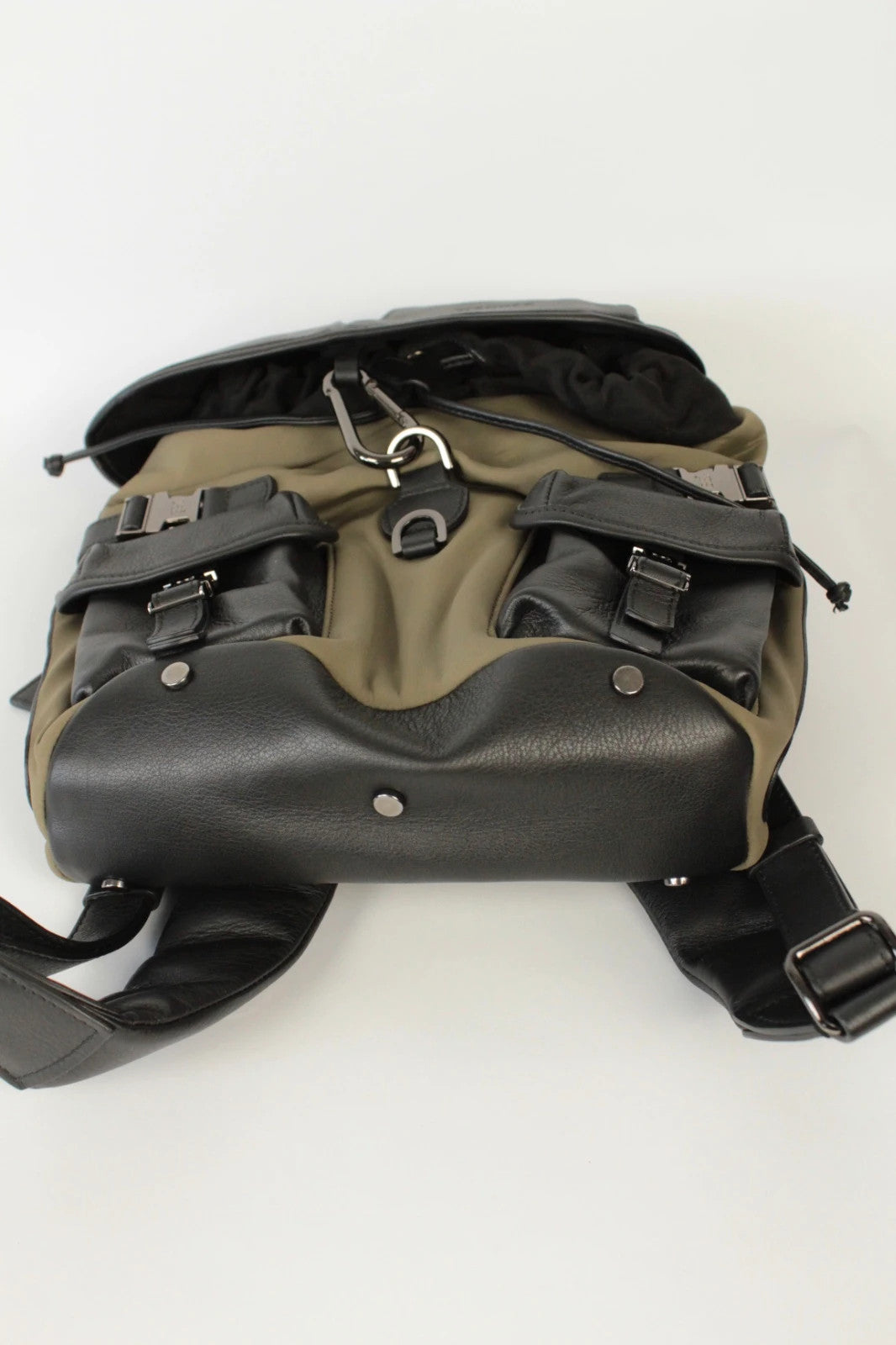 Hènope black and military green neoprene backpack with calf leather trim and gunmetal hardware.