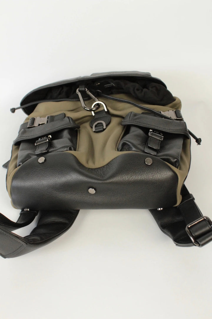 Hènope black and military green neoprene backpack with calf leather trim and gunmetal hardware.