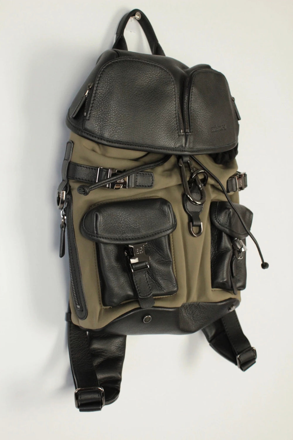 Hènope black and military green neoprene backpack with calf leather trim and gunmetal hardware.
