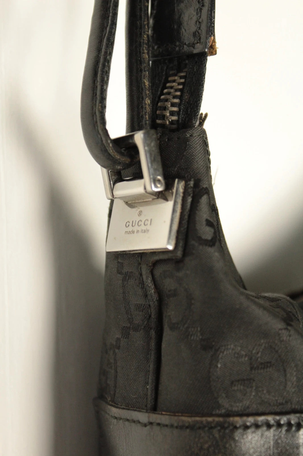 Gucci black hobo bag with GG monogram canvas, calf leather trim, and silver-tone hardware.