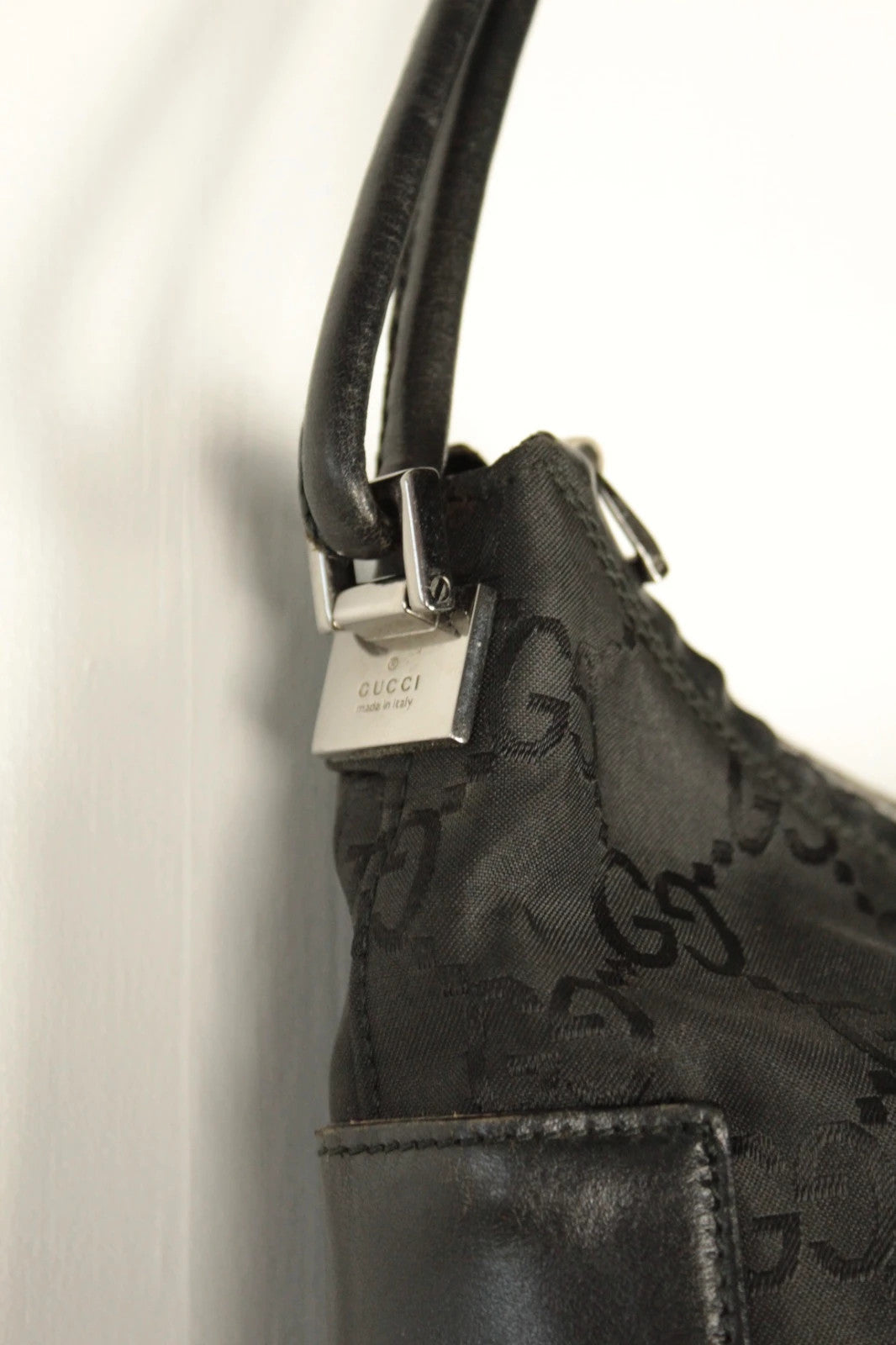 Gucci black hobo bag with GG monogram canvas, calf leather trim, and silver-tone hardware.
