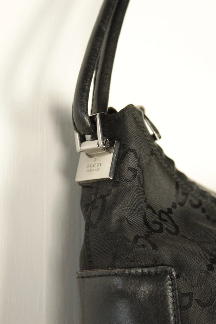 Gucci black hobo bag with GG monogram canvas, calf leather trim, and silver-tone hardware.