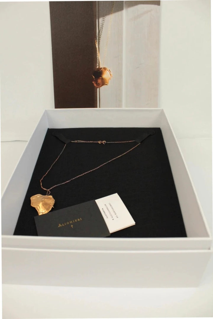 Alighieri gold molten pendant necklace with textured abstract design and presentation box.