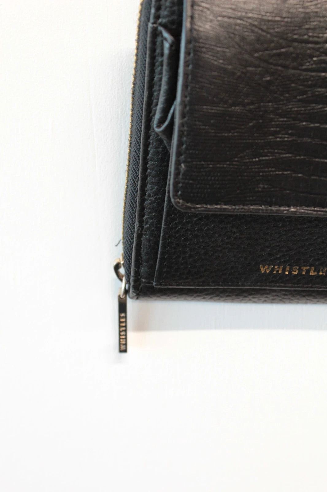 Whistles black lizard effect leather crossbody bag with gold-tone logo and zip hardware.