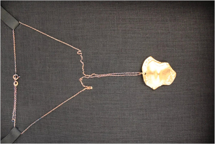 Alighieri gold molten pendant necklace with textured abstract design and presentation box.