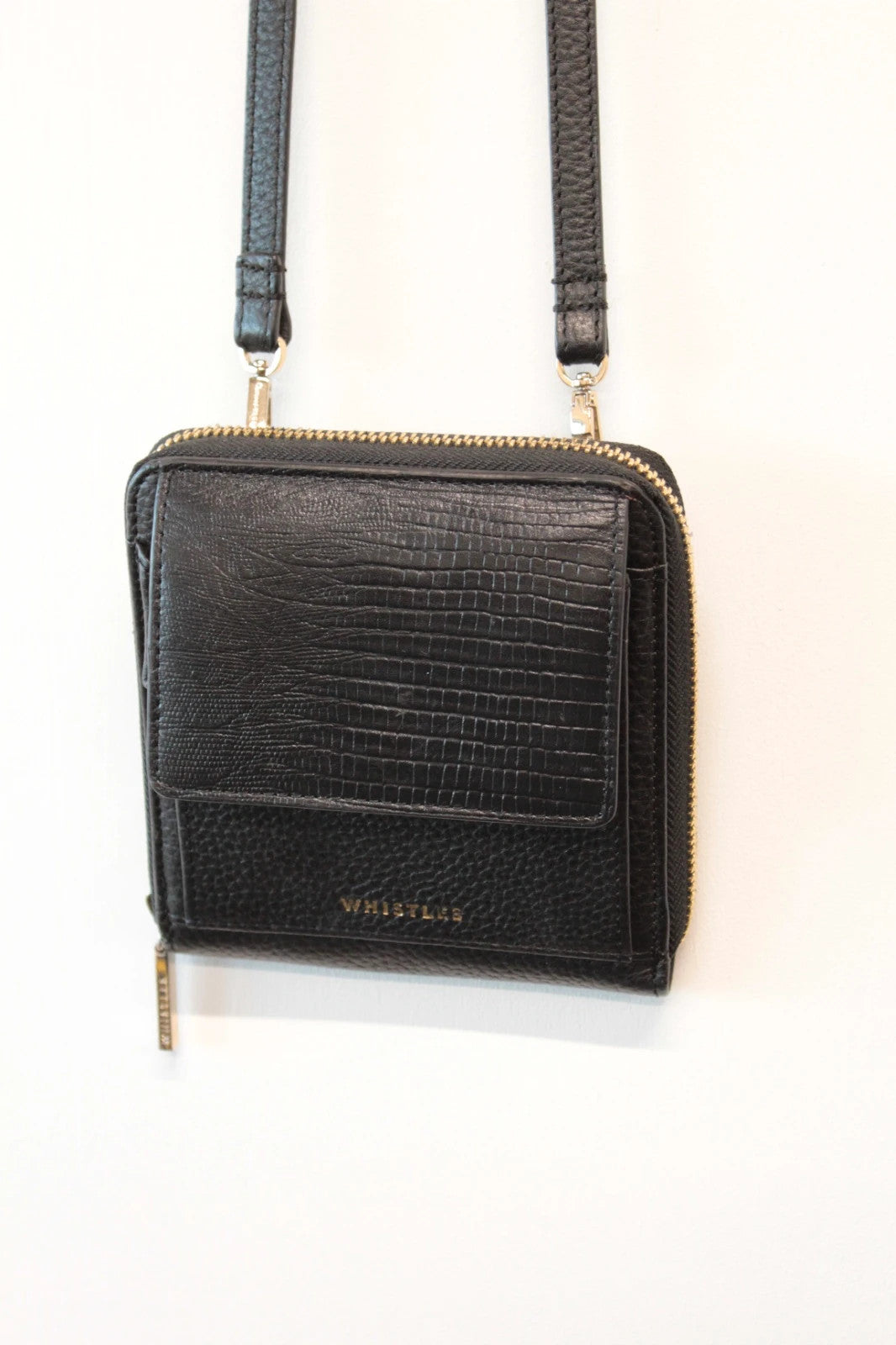 Whistles black lizard effect leather crossbody bag with gold-tone logo and zip hardware.