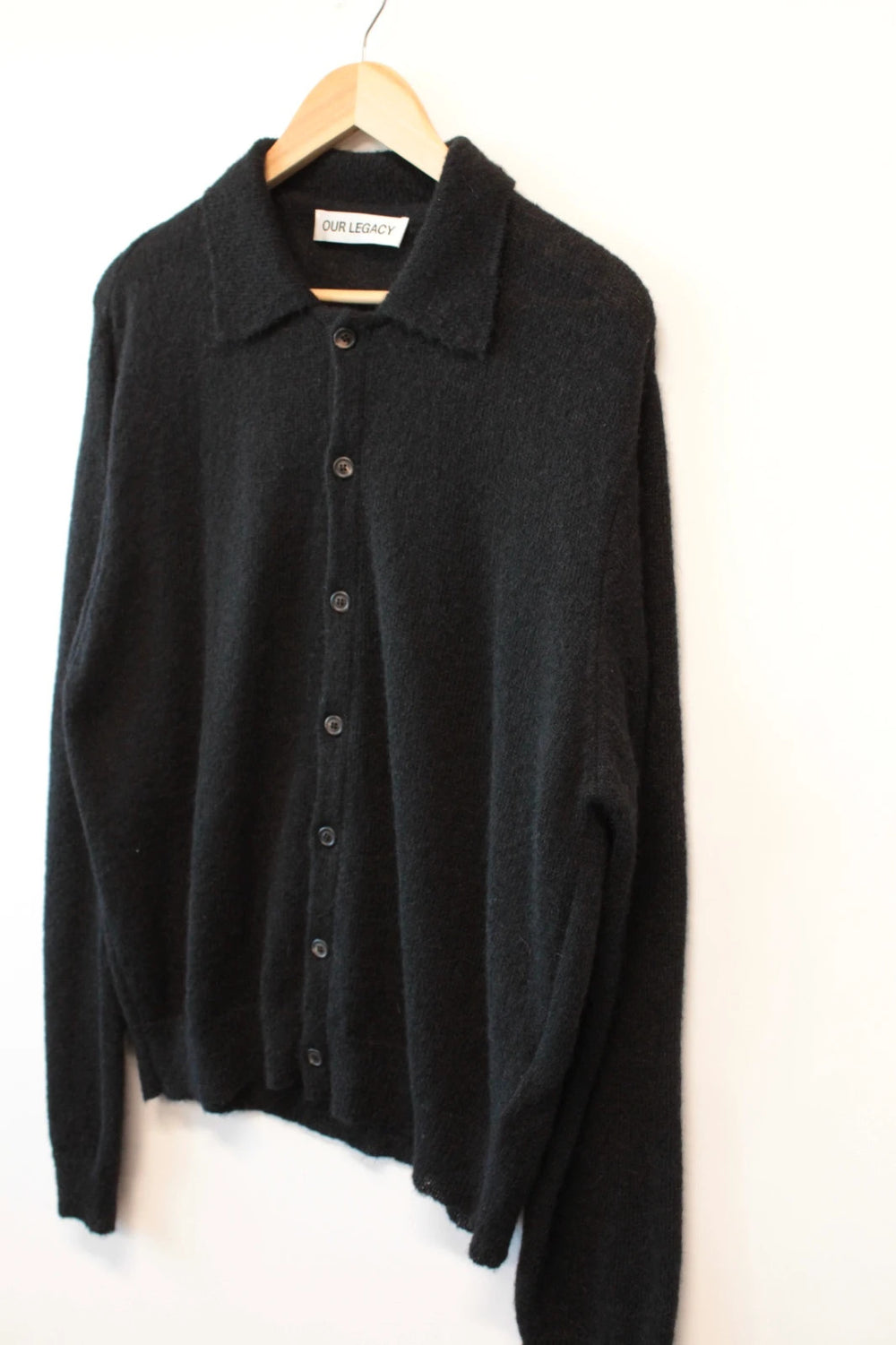 Our Legacy black mohair cardigan with classic collar and tonal buttons.
