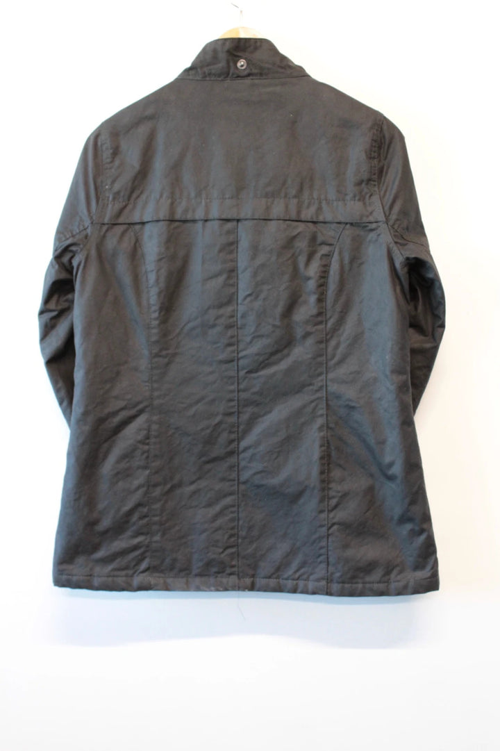 Barbour black waxed cotton jacket with tartan pattern and corduroy collar accent.