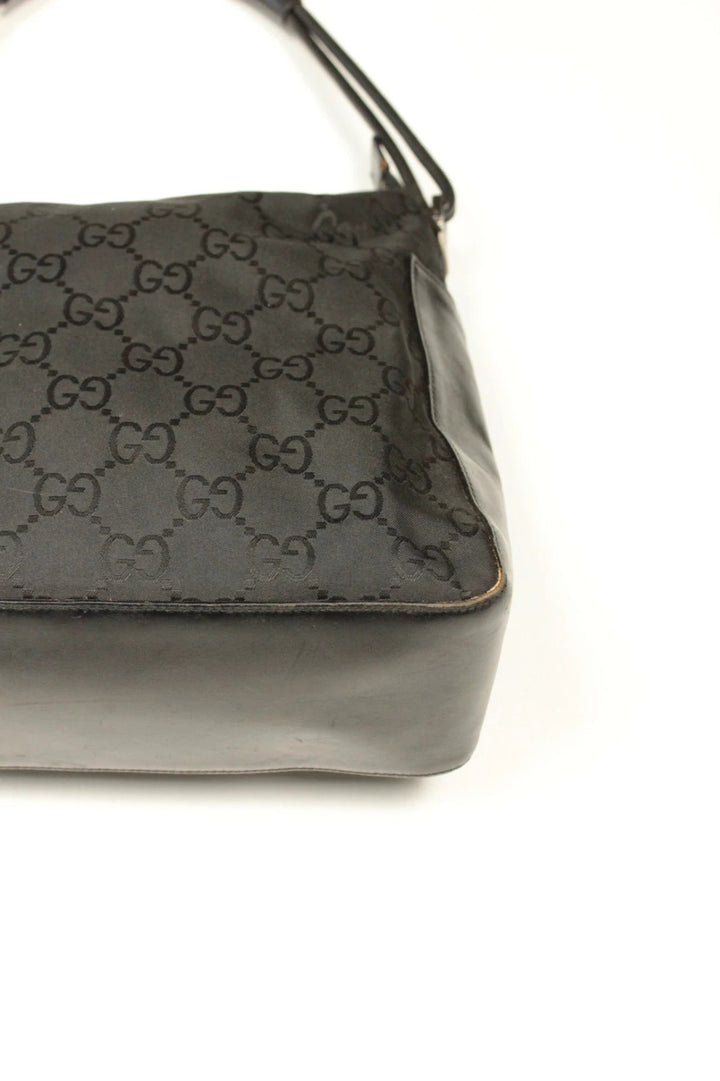 Gucci black hobo bag with GG monogram canvas, calf leather trim, and silver-tone hardware.