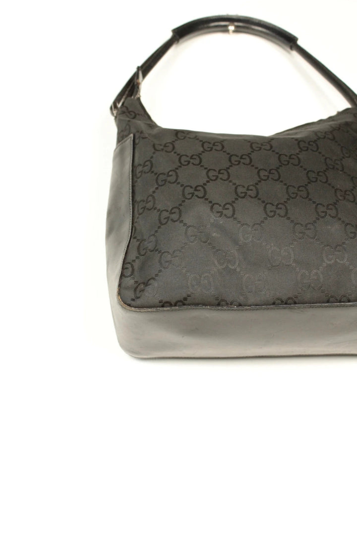 Gucci black hobo bag with GG monogram canvas, calf leather trim, and silver-tone hardware.