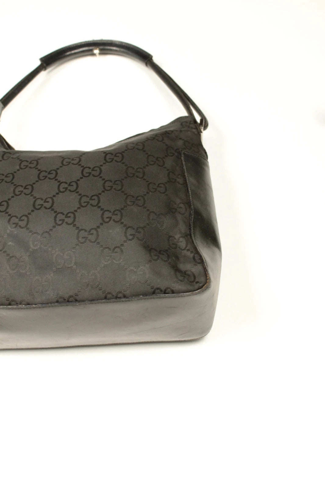 Gucci black hobo bag with GG monogram canvas, calf leather trim, and silver-tone hardware.
