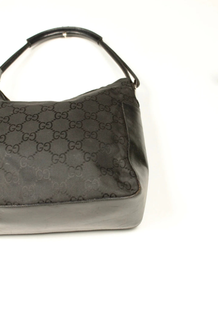 Gucci black hobo bag with GG monogram canvas, calf leather trim, and silver-tone hardware.