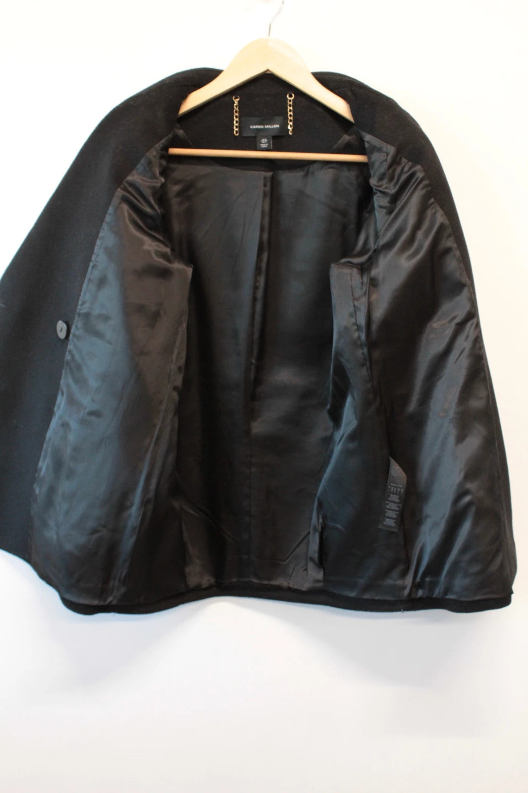 Karen Millen black double-breasted pea coat with tailored silhouette and gold hanging chain.