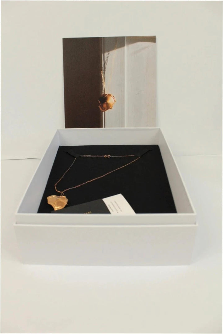 Alighieri gold molten pendant necklace with textured abstract design and presentation box.
