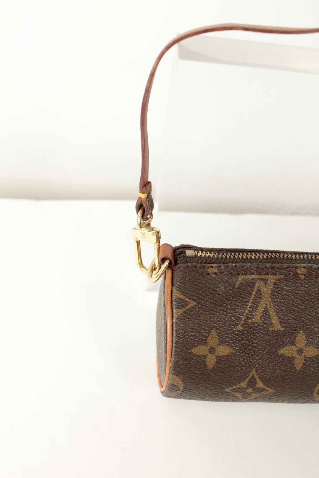 Louis Vuitton brown micro mini pouch bag with monogram pattern and vachetta leather trim.